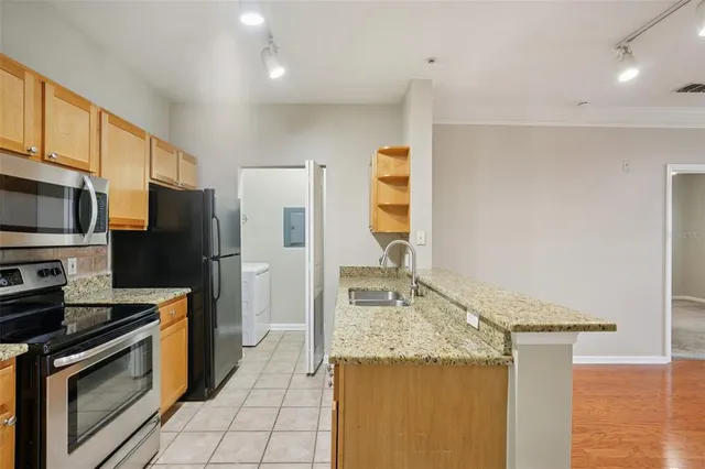 a kitchen with a sink stove and cabinets