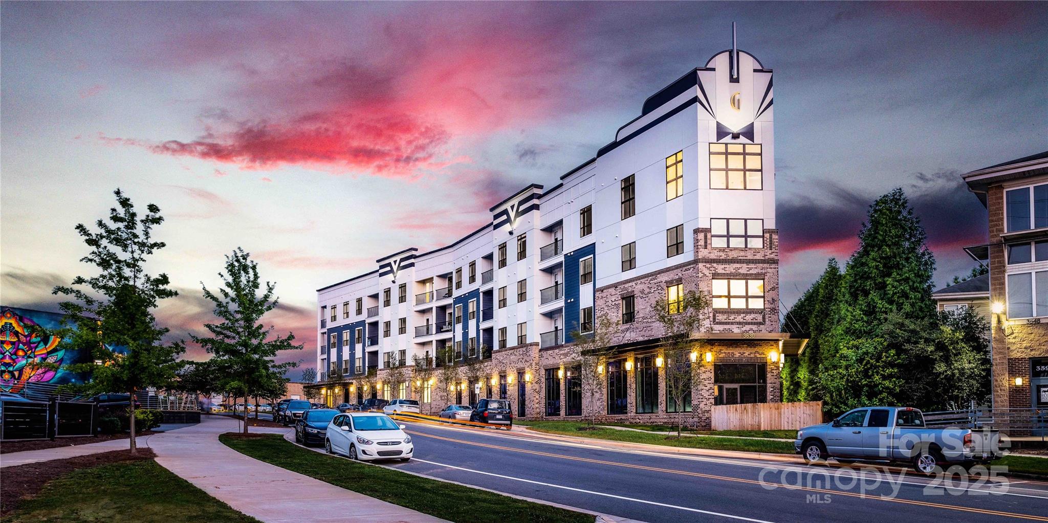 a city street lined with buildings and trees