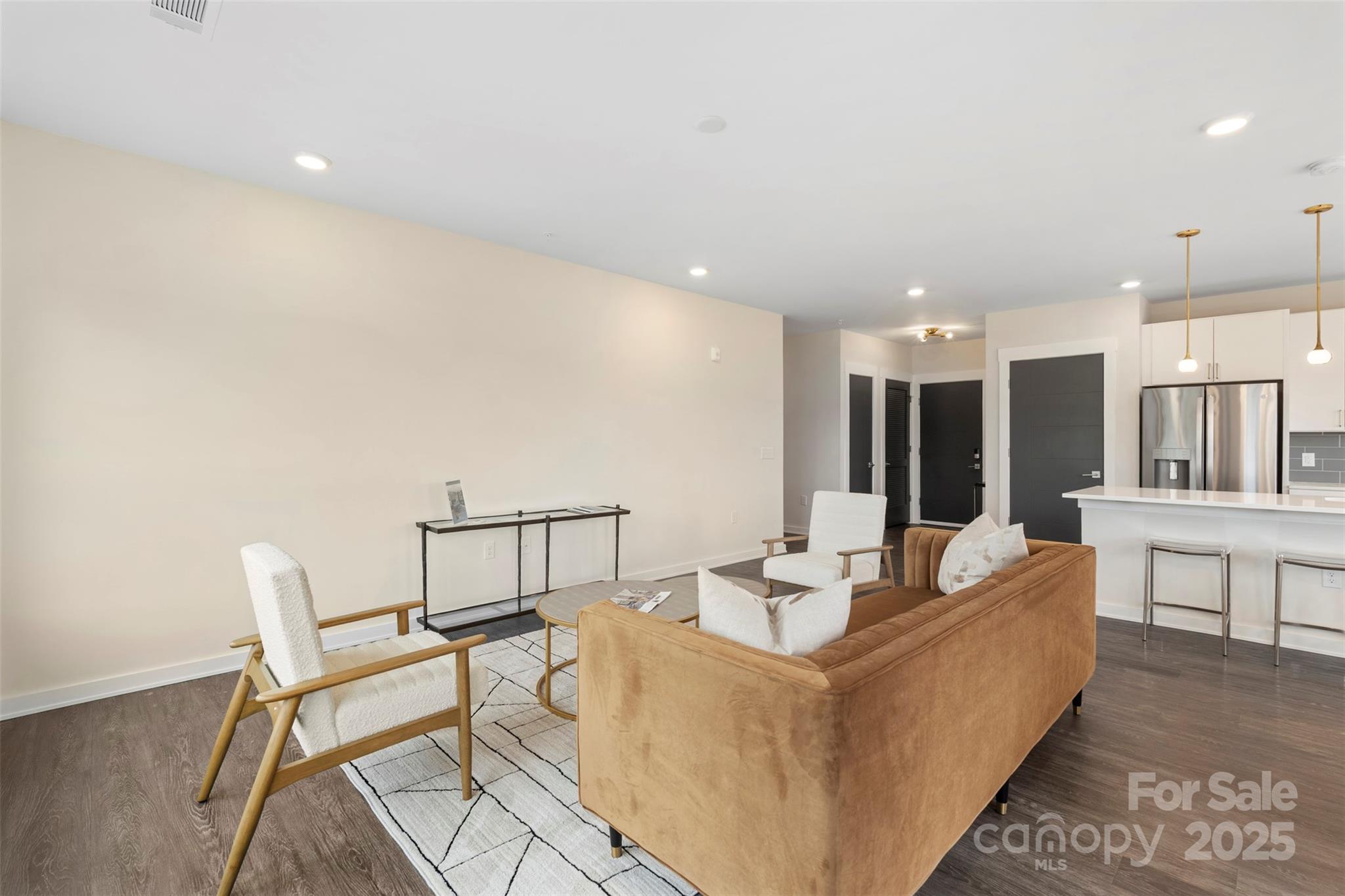 3630 North Davidson Street, Unit 3301 Charlotte, NC 28205 - Photo 14 of 33 a living room with couches and kitchen view with wooden floor