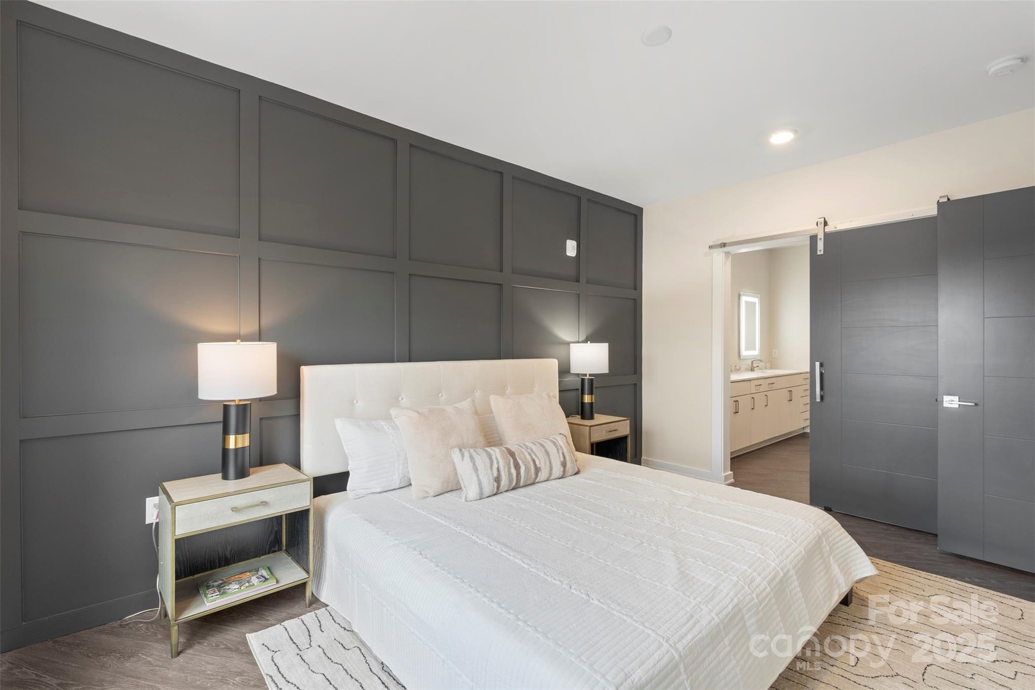 3630 North Davidson Street, Unit 3301 Charlotte, NC 28205 - Photo 16 of 33 a bedroom with a bed and a lamp