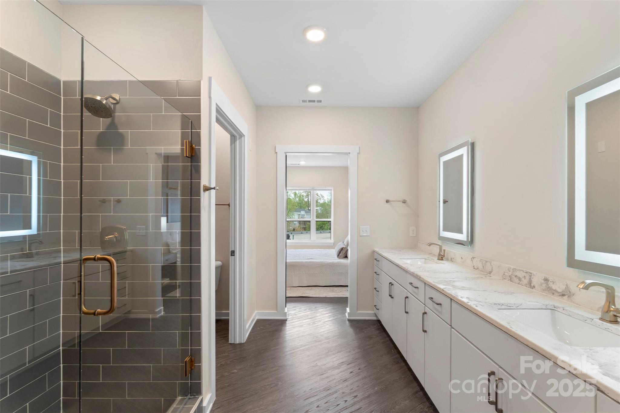 3630 North Davidson Street, Unit 3301 Charlotte, NC 28205 - Photo 19 of 33 a bathroom with a double vanity sink a large mirror and shower
