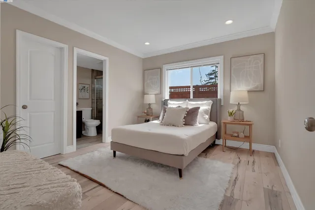 a spacious bedroom with a bed and a cabinets