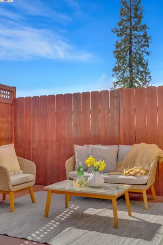a view of patio with table and chairs with wooden fence