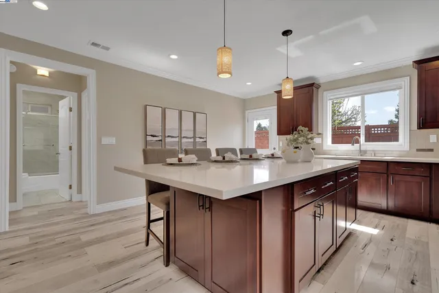 a kitchen with granite countertop a sink appliances and cabinets