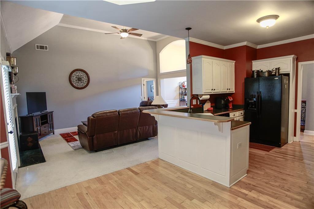 3875 Spring Manor Court Loganville, GA 30052 - Photo 10 of 23 a kitchen with a refrigerator and a stove