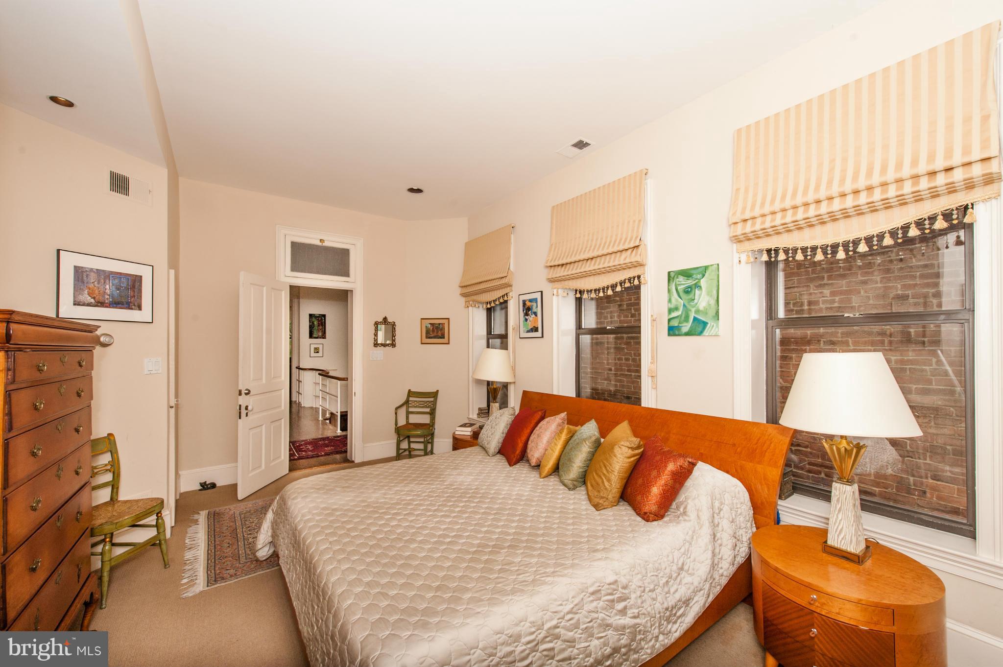 1318 Rhode Island Avenue Northwest Washington, DC 20005 - Photo 14 of 25 a bedroom with a bed and wooden floor