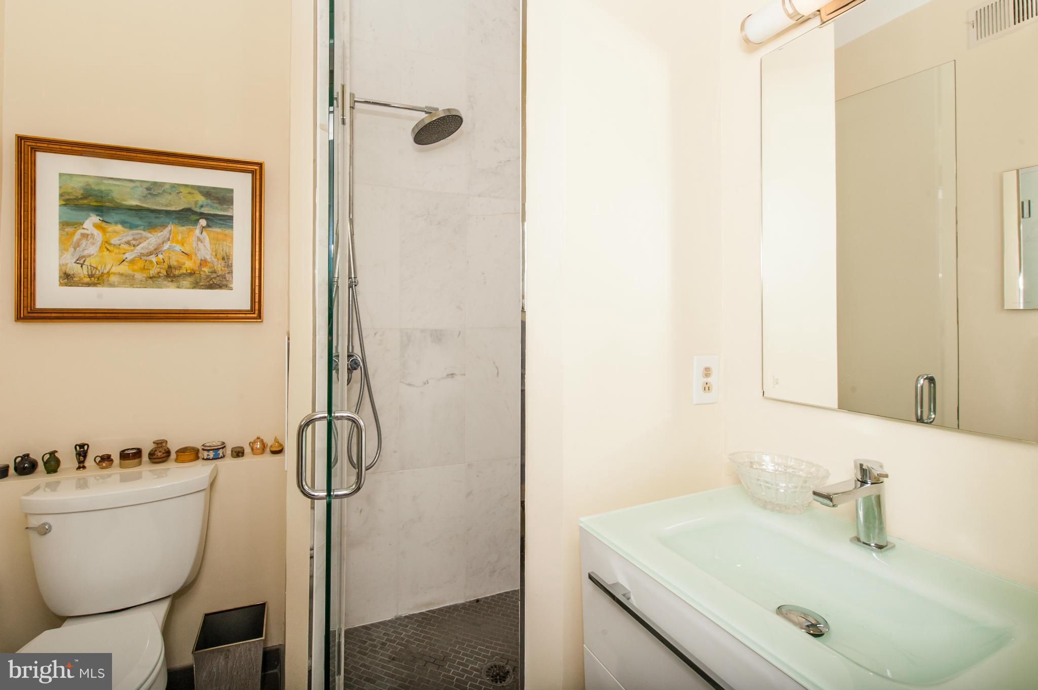 1318 Rhode Island Avenue Northwest Washington, DC 20005 - Photo 20 of 25 a bathroom with a sink and mirror with toilet