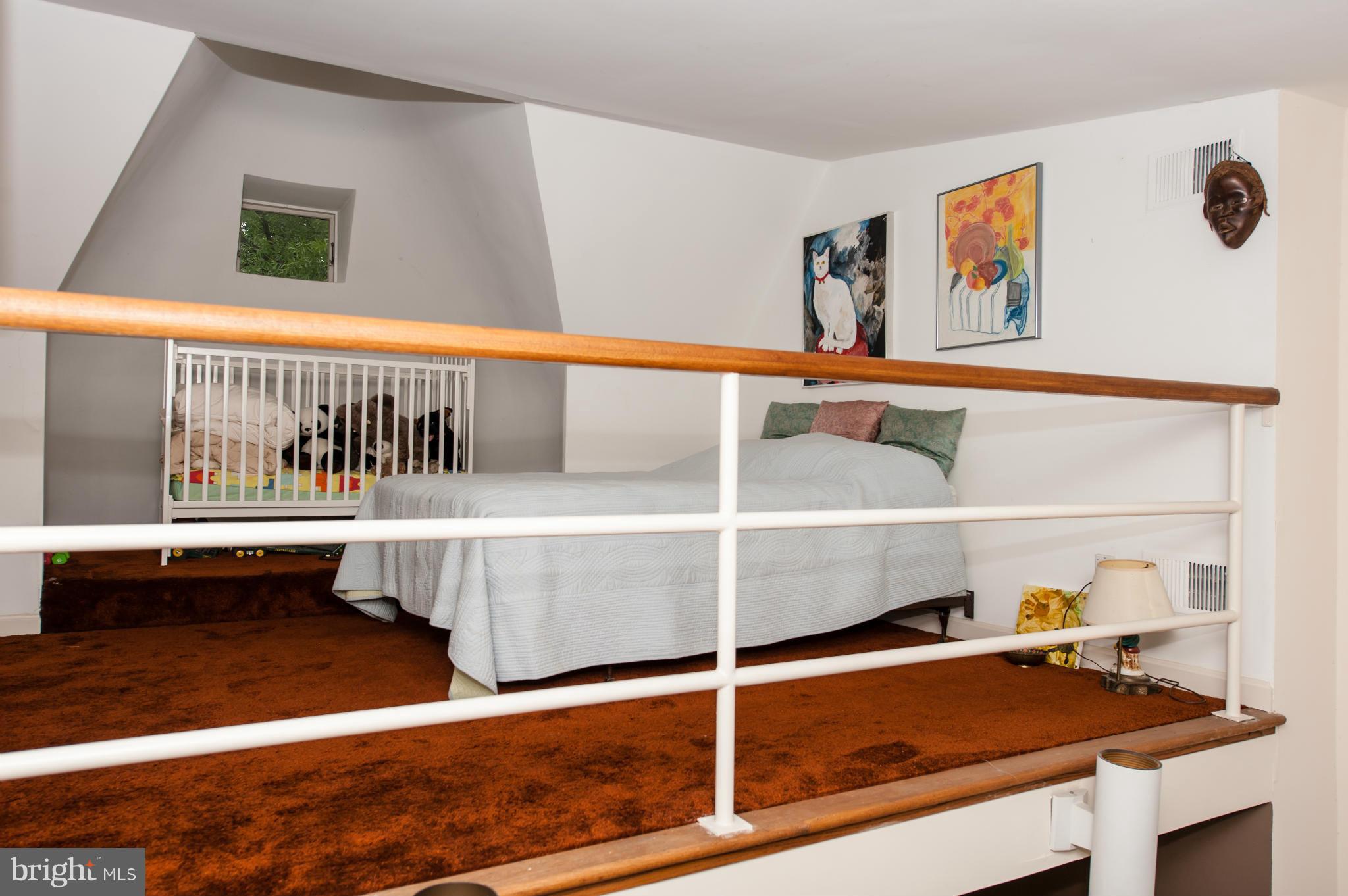 1318 Rhode Island Avenue Northwest Washington, DC 20005 - Photo 23 of 25 a bed room with a bed and a window