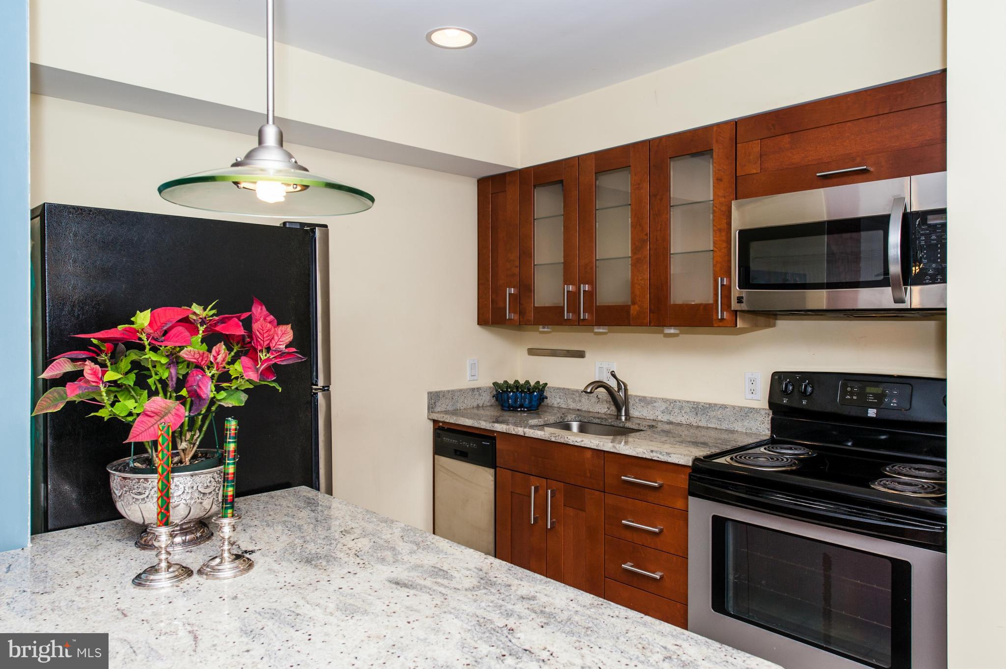 1318 Rhode Island Avenue Northwest Washington, DC 20005 - Photo 25 of 25 a kitchen with stainless steel appliances granite countertop a sink stove and microwave