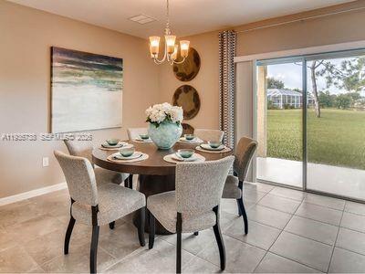 943 Riviera Avenue Sebastian, FL 32958 - Photo 3 of 10 a dining room with furniture a chandelier and wooden floor