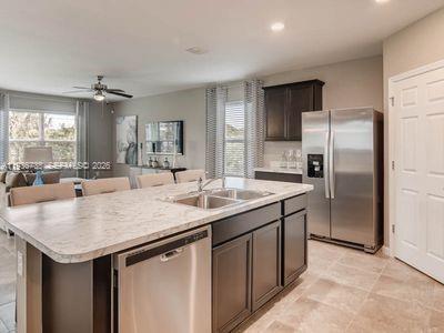 943 Riviera Avenue Sebastian, FL 32958 - Photo 4 of 10 a kitchen with stainless steel appliances granite countertop a sink and a refrigerator