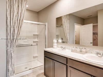 943 Riviera Avenue Sebastian, FL 32958 - Photo 6 of 10 a bathroom with a granite countertop sink mirror and double