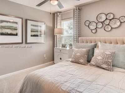 943 Riviera Avenue Sebastian, FL 32958 - Photo 7 of 10 a bedroom with a large bed and a window