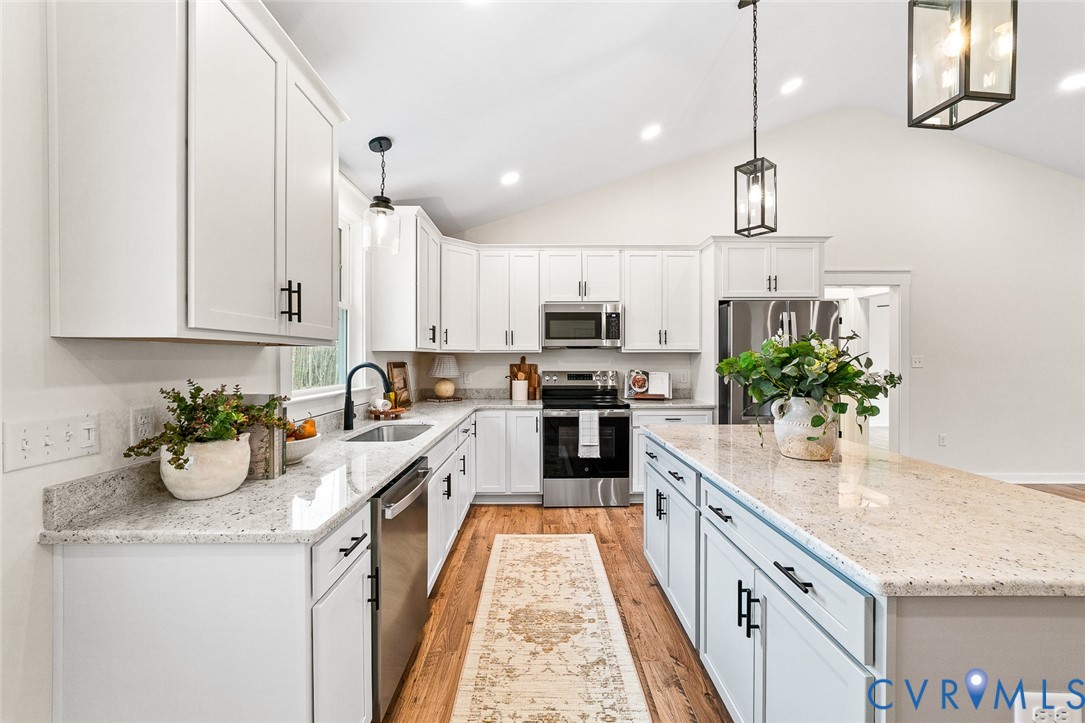 235 Bumpass Road Bumpass, VA 23024 - Photo 11 of 28 a kitchen with kitchen island granite countertop a sink a counter space appliances and cabinets