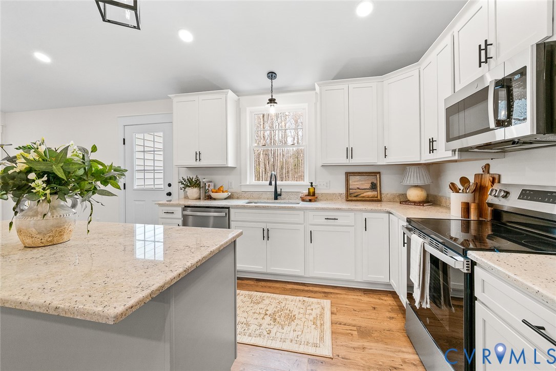 235 Bumpass Road Bumpass, VA 23024 - Photo 12 of 28 a kitchen with granite countertop a sink stainless steel appliances and cabinets