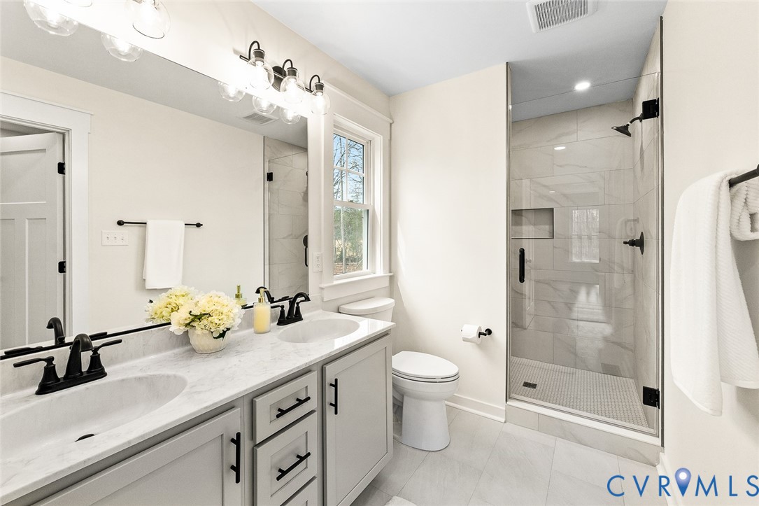 235 Bumpass Road Bumpass, VA 23024 - Photo 16 of 28 a bathroom with a double vanity sink mirror double and shower