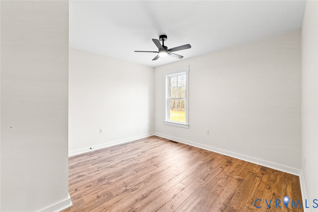 235 Bumpass Road Bumpass, VA 23024 - Photo 18 of 28 an empty room with a window and a ceiling fan