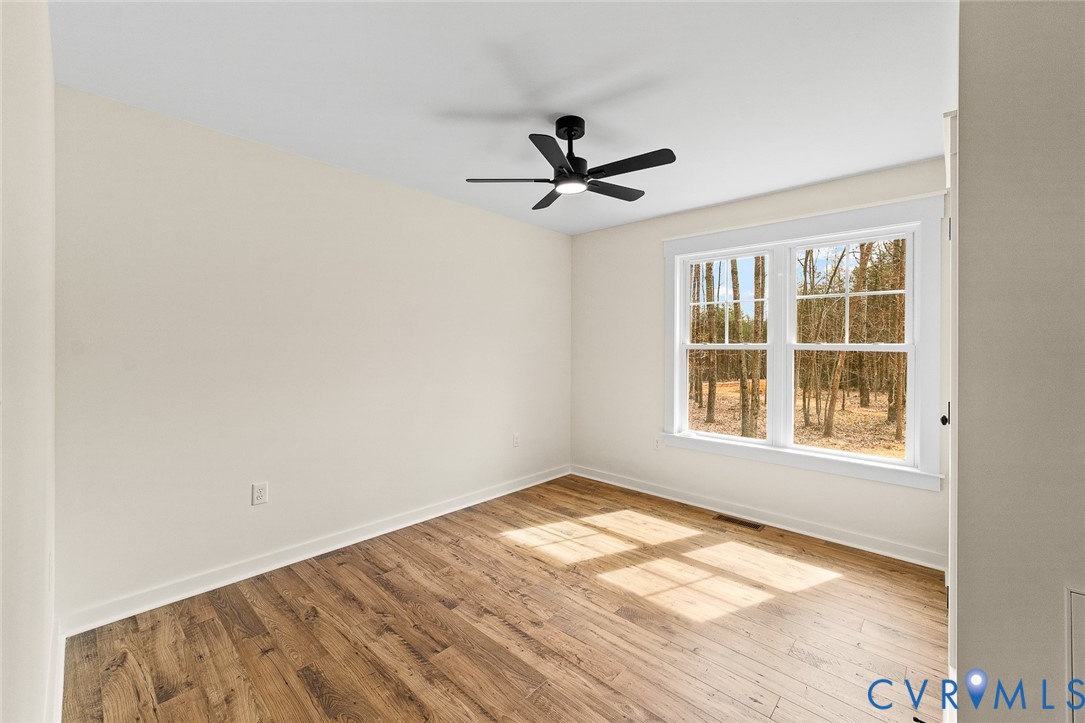 235 Bumpass Road Bumpass, VA 23024 - Photo 22 of 28 a view of empty room with wooden floor and fan