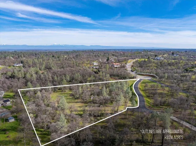 an aerial view of mountain with trees around