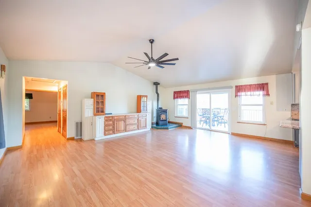 a large kitchen with stainless steel appliances granite countertop a refrigerator and a sink