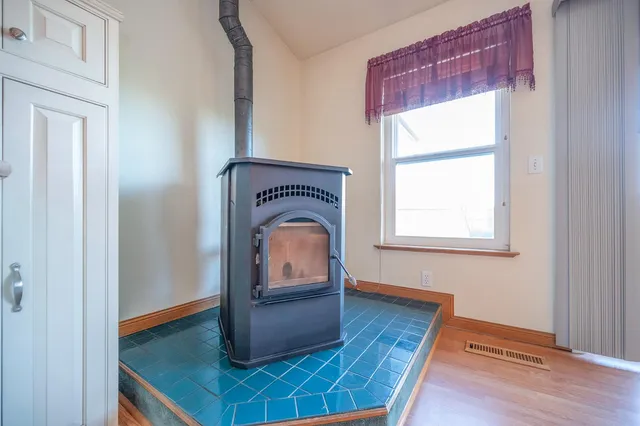 a kitchen with granite countertop a stove and cabinets