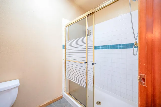 a view of a house with a yard and hanging chair