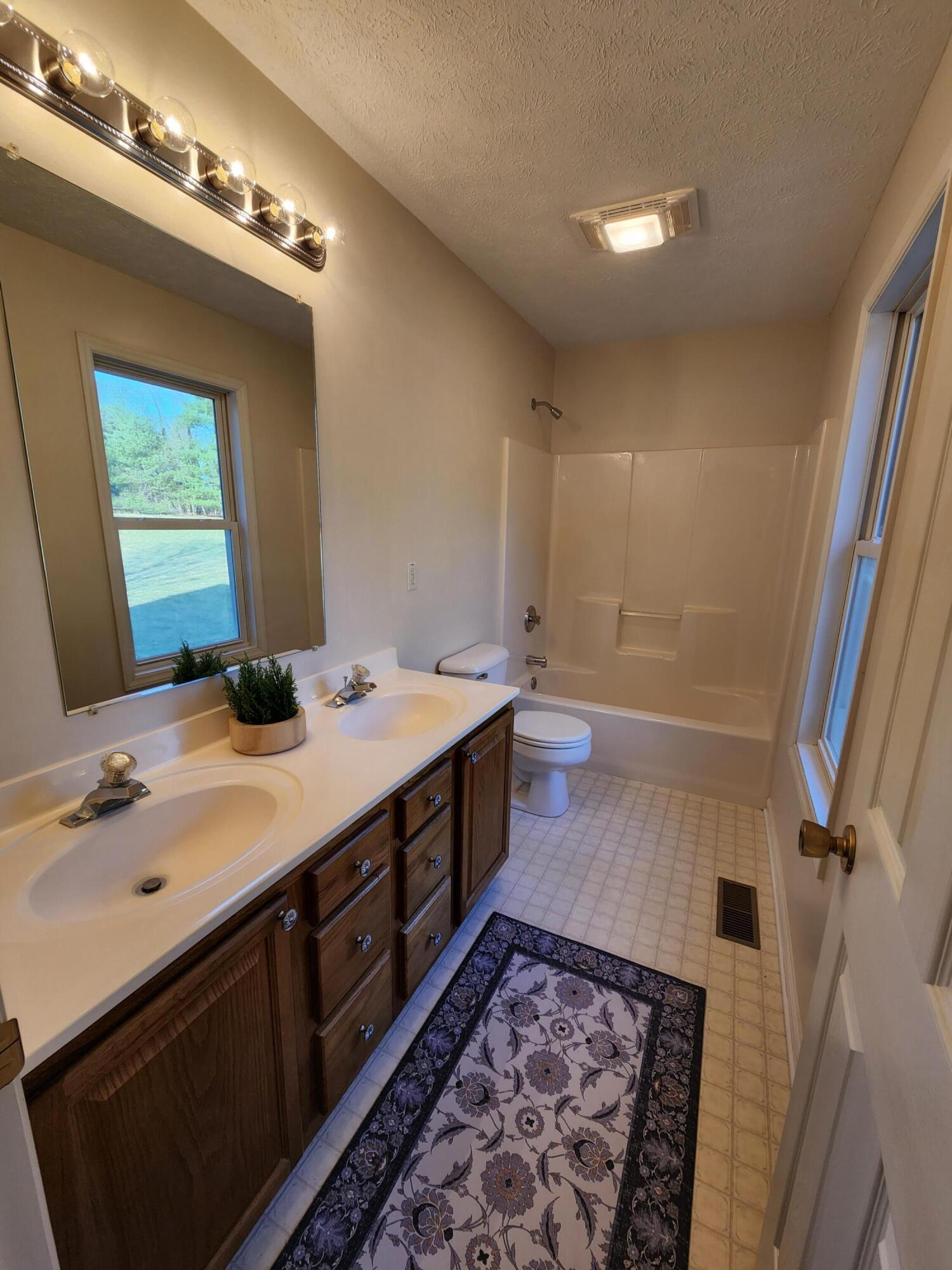 603 Middle Valley Road Hardy, VA 24101 - Photo 35 of 74 a bathroom with a double vanity sink and a mirror