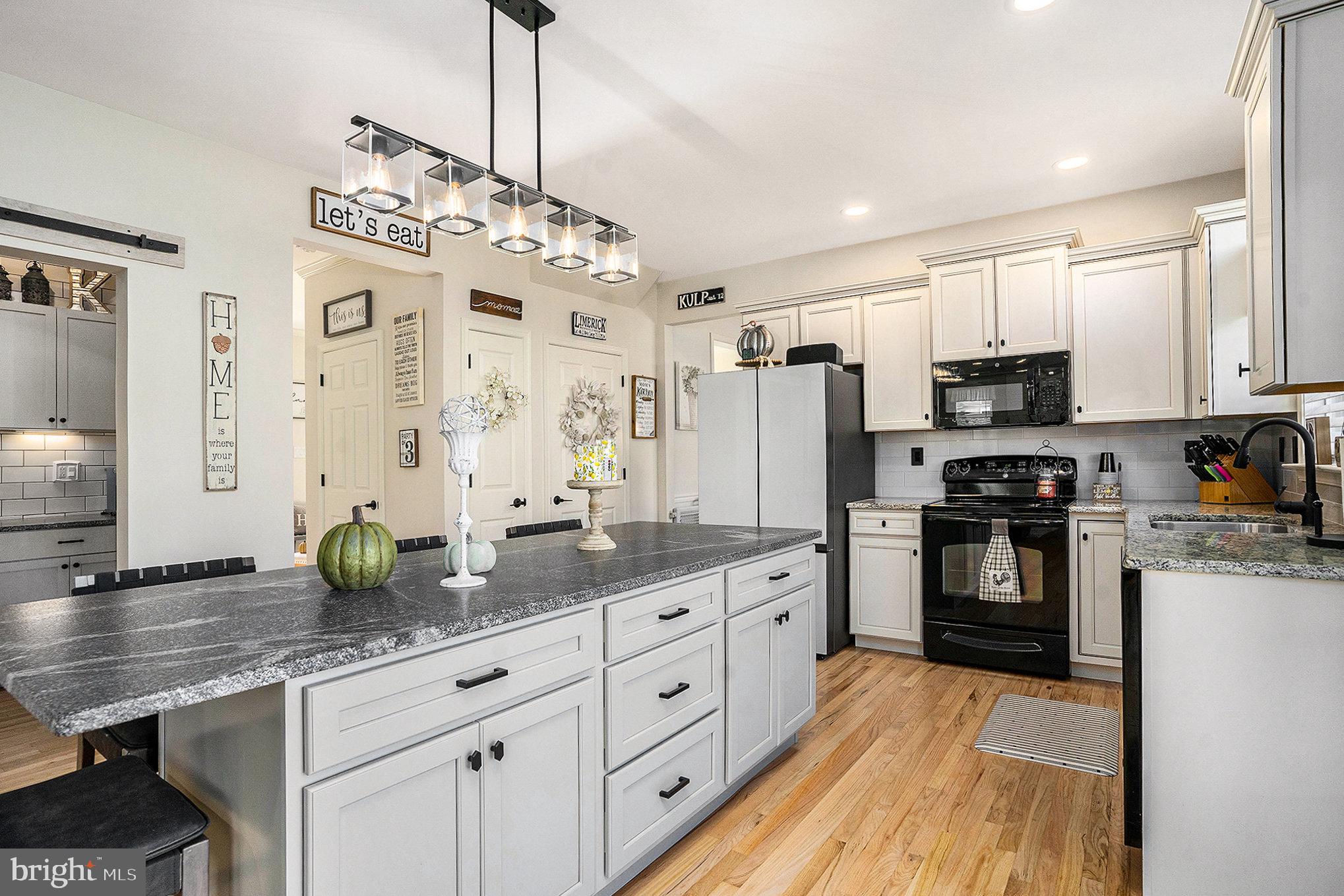 20 Bunker Way Pottstown, PA 19464 - Photo 16 of 45 a kitchen with refrigerator a stove and cabinets