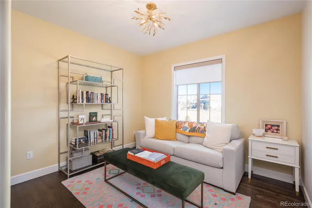 a living room with furniture and a book shelf