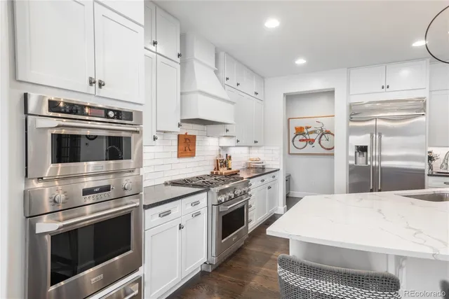 a kitchen with stainless steel appliances a stove a microwave and cabinets