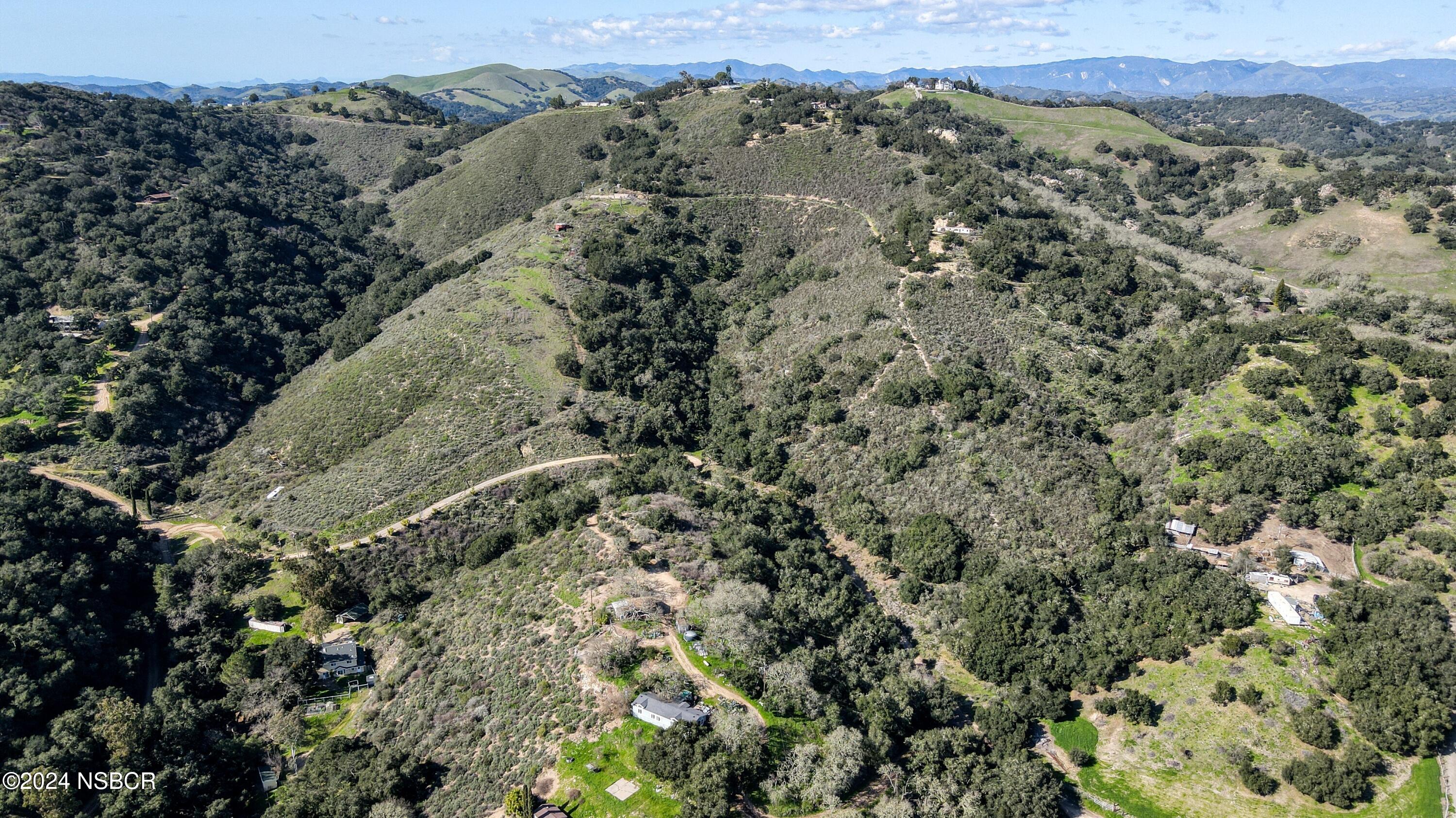 9339 Temettate Drive Santa Maria, CA 93454 - Photo 35 of 41 a view of a forest with mountains in the background