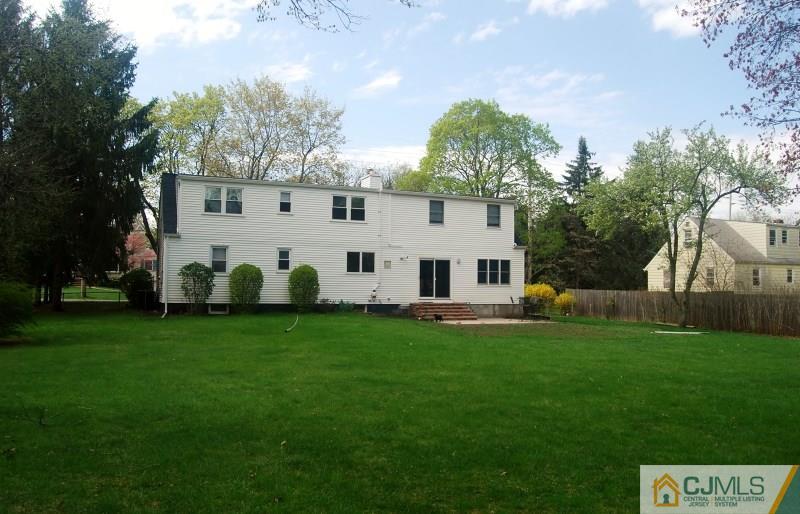 103 Wilson Road Somerset, NJ 08873 - Photo 14 of 14 a view of a white house with a big yard and large trees