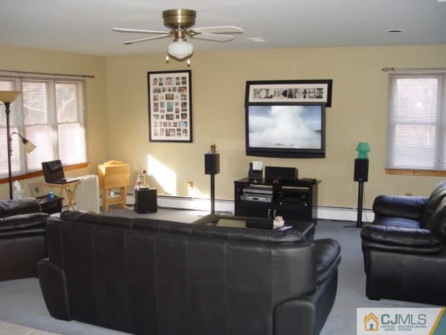 103 Wilson Road Somerset, NJ 08873 - Photo 3 of 14 a living room with furniture a piano and a flat screen tv
