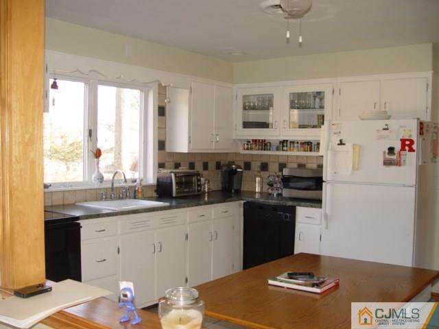 103 Wilson Road Somerset, NJ 08873 - Photo 4 of 14 a kitchen with stainless steel appliances granite countertop a stove a sink and a refrigerator
