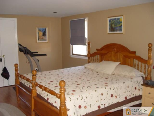 103 Wilson Road Somerset, NJ 08873 - Photo 9 of 14 a bedroom with bed and wooden floor