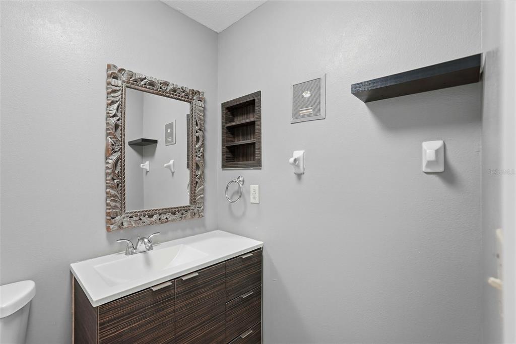 11709 Raintree Village Boulevard, Unit C Temple Terrace, FL 33617 - Photo 12 of 23 a bathroom with a sink and a mirror