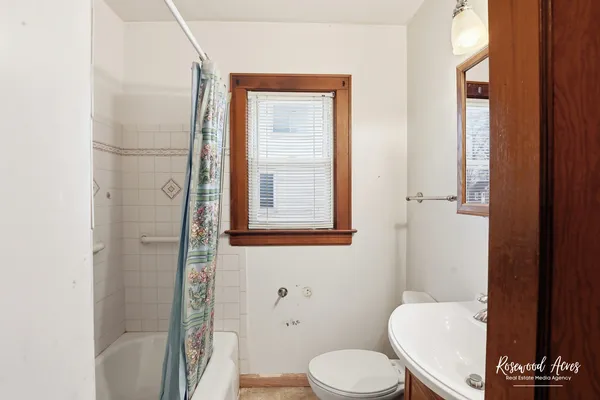 a white toilet sitting next to a bathroom sink