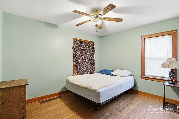 a bedroom with a bed and a ceiling fan