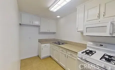 a bathroom with a granite countertop sink a mirror and shower