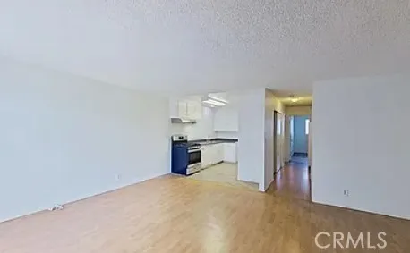 an empty room with floor to ceiling window and fireplace