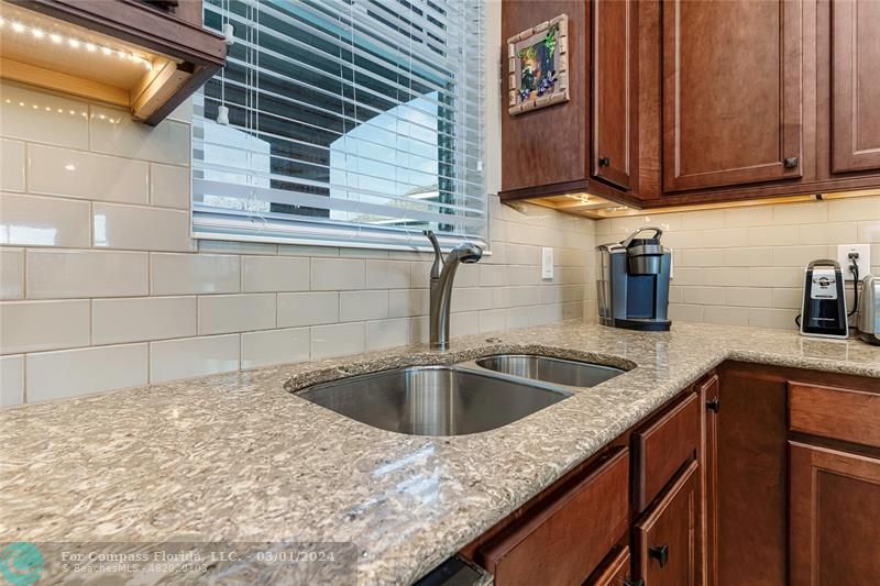 9857 Southwest 99th Loop Ocala, FL 34481 - Photo 13 of 45 a kitchen with granite countertop sink and cabinets