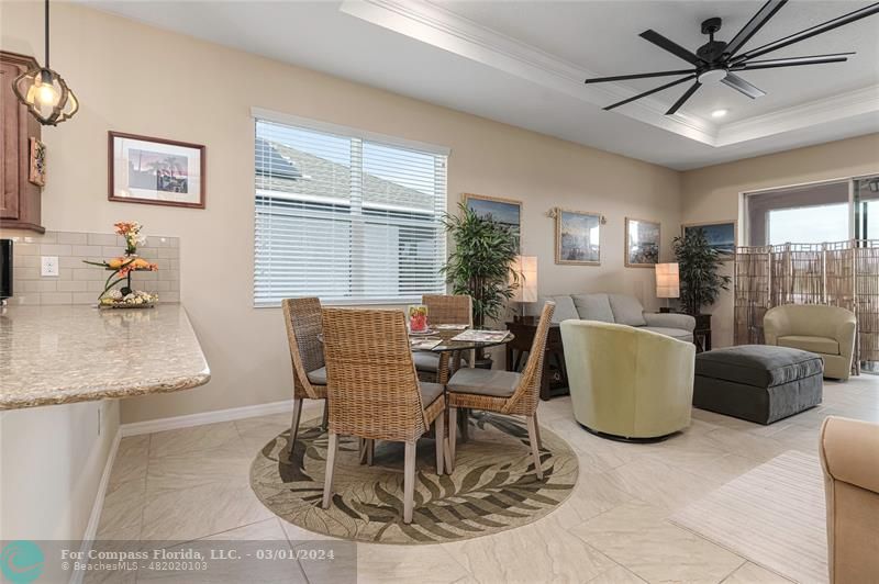 9857 Southwest 99th Loop Ocala, FL 34481 - Photo 14 of 45 a dining room with furniture a window and a chandelier