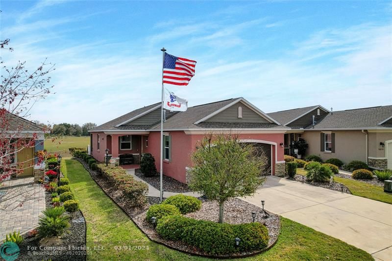 9857 Southwest 99th Loop Ocala, FL 34481 - Photo 2 of 45 a front view of a house with a yard