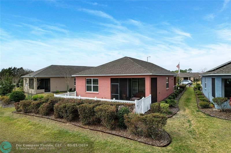 9857 Southwest 99th Loop Ocala, FL 34481 - Photo 4 of 45 a front view of a house with a yard