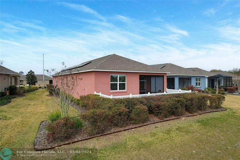 9857 Southwest 99th Loop Ocala, FL 34481 - Photo 5 of 45 a front view of a house with garden