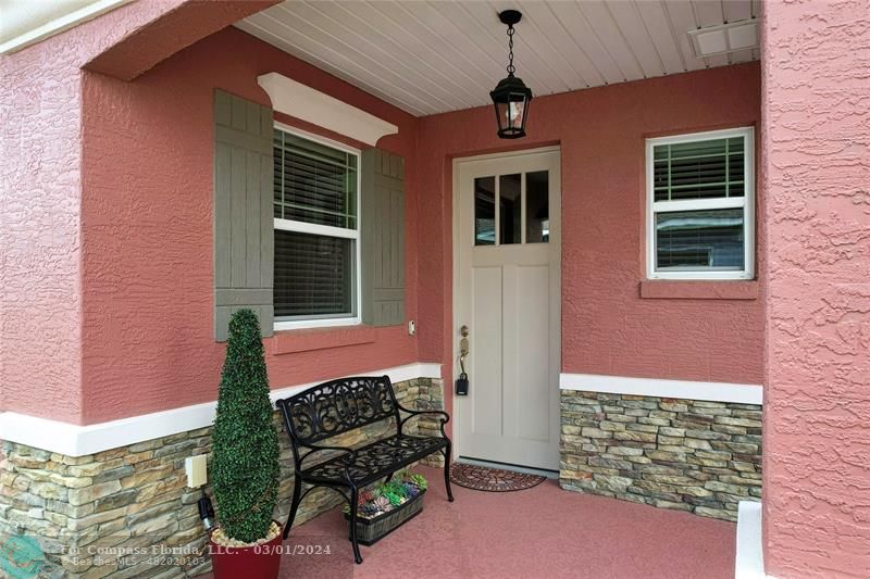 9857 Southwest 99th Loop Ocala, FL 34481 - Photo 9 of 45 a front view of a house with a yard