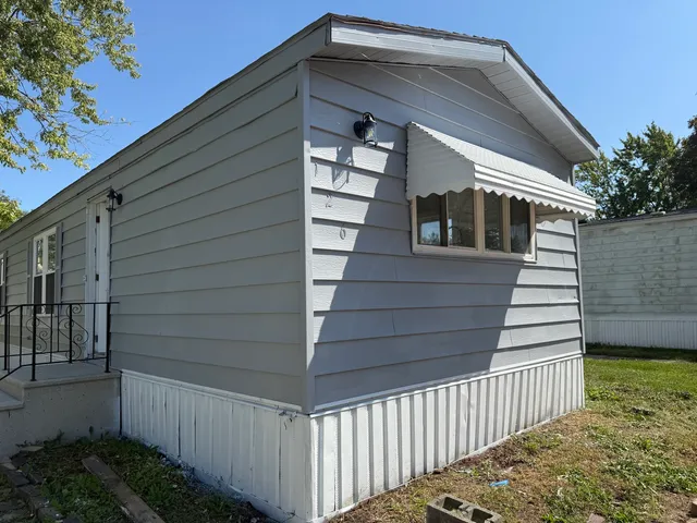 a front view of house with wooden fence