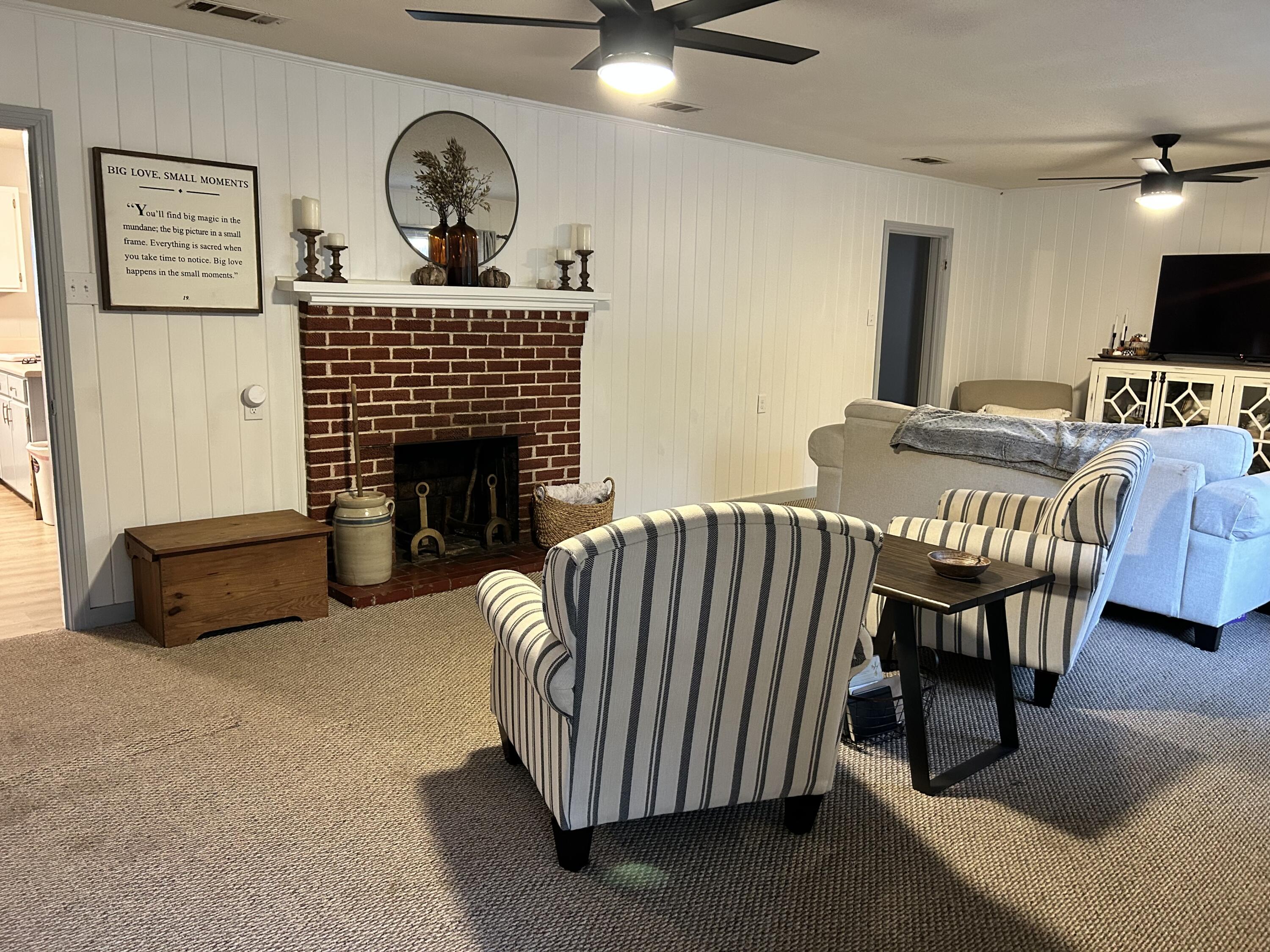 1764 Adams Road DeFuniak Springs, FL 32433 - Photo 17 of 30 a living room with furniture a fireplace and a flat screen tv