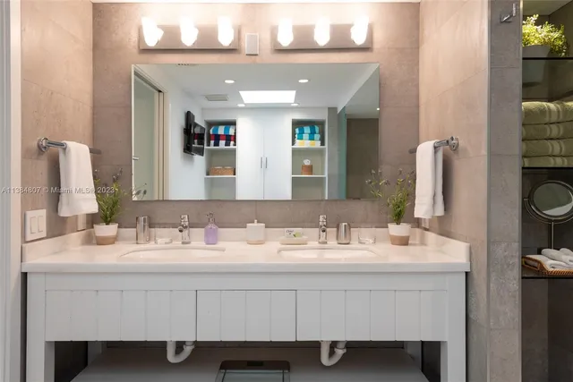 a bathroom with a sink a toilet and mirror