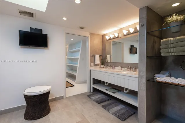 a bedroom with a large bed and a flat screen tv